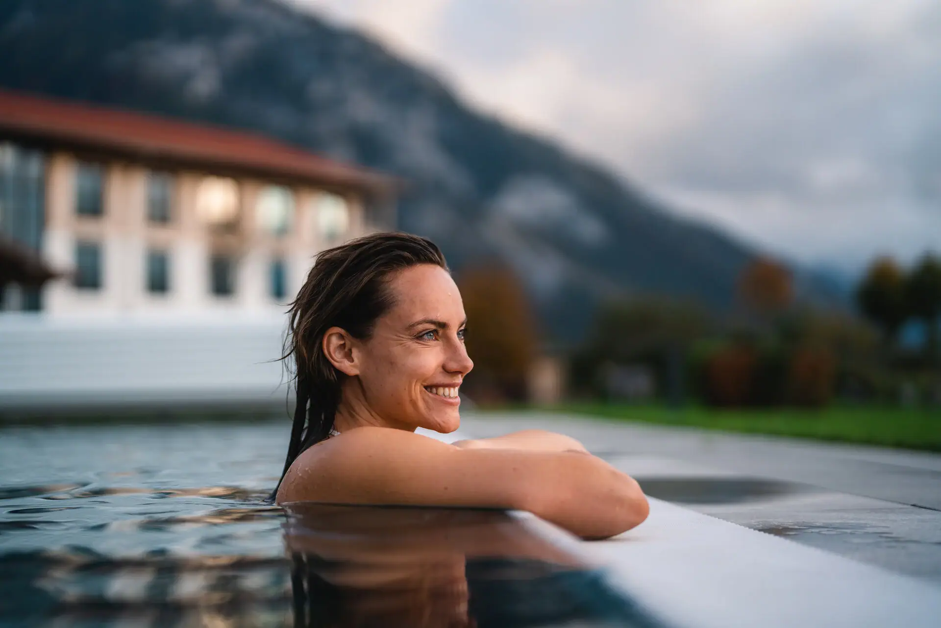 Woman swimming in an outdoor pool.