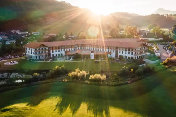 aja Ruhpolding A large building with a large lawn and a car park in the foreground.
