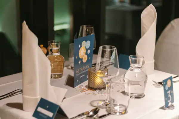 A table with a candle and glasses.