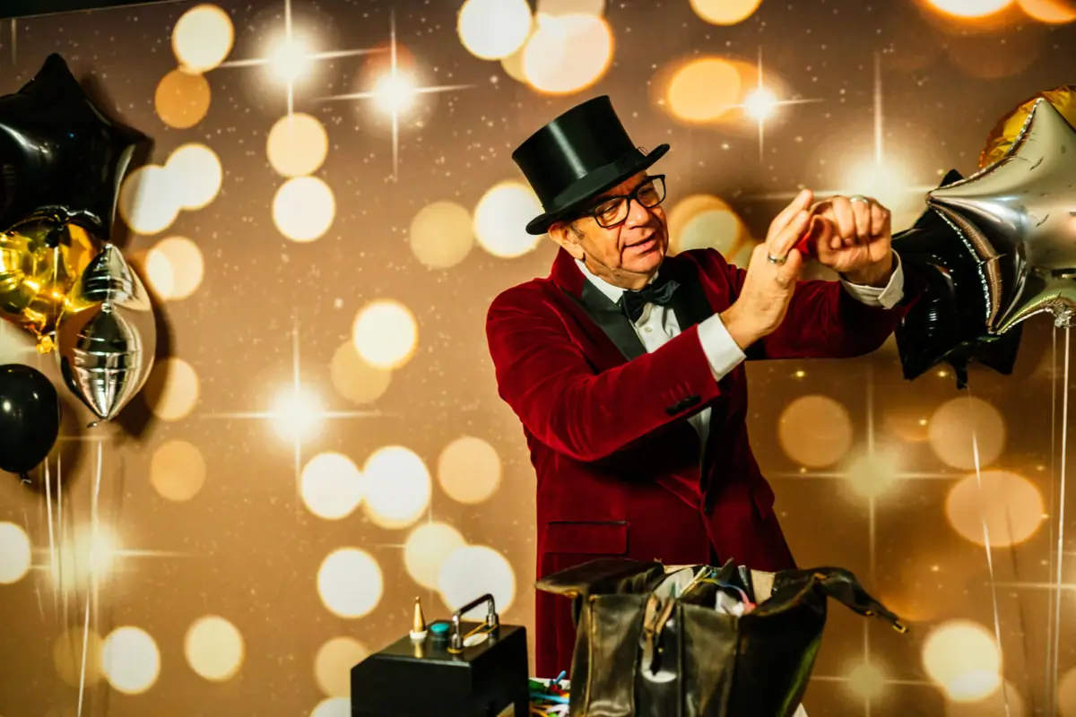 A man in a red suit and top hat.