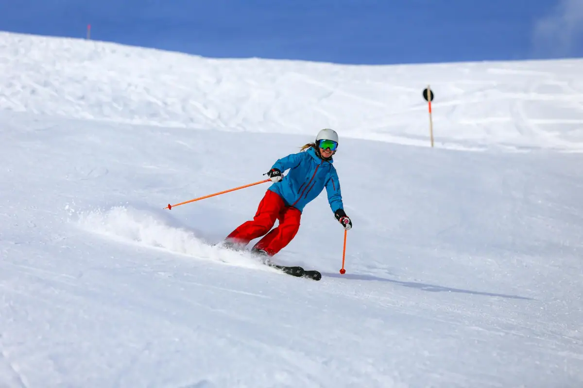 A woman skis down a snow-covered slope.