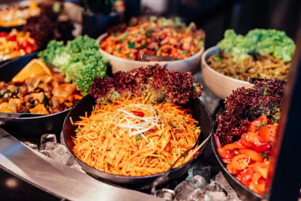 A group of bowls filled with various foods.