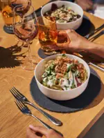 On one table you can see 2 bowls with beautifully arranged dishes.