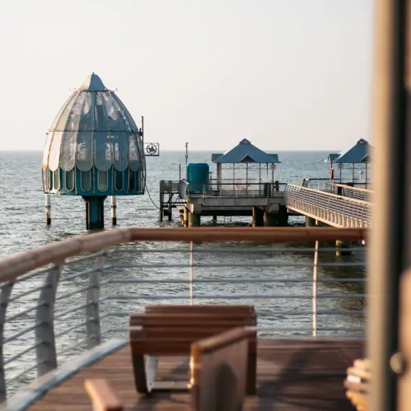 A view from a deck across the water towards a jetty.