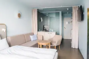 Double room  A room with a sofa and a table.