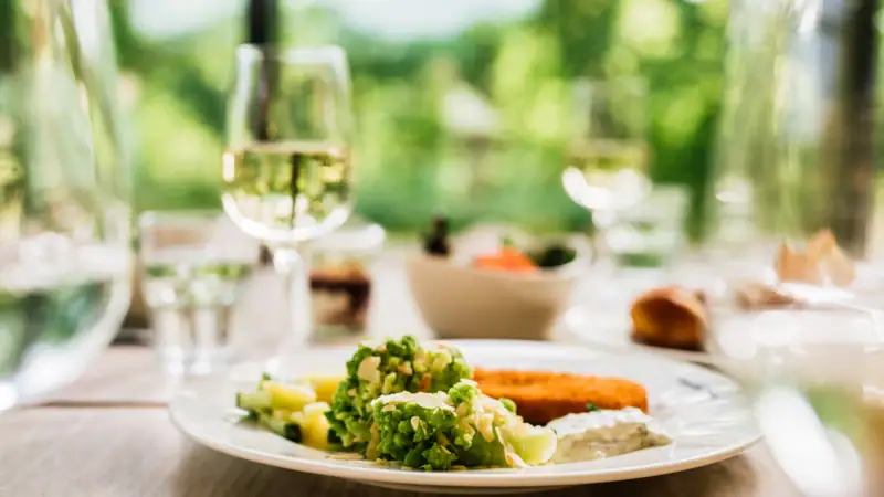 A plate of food and a glass of wine.
