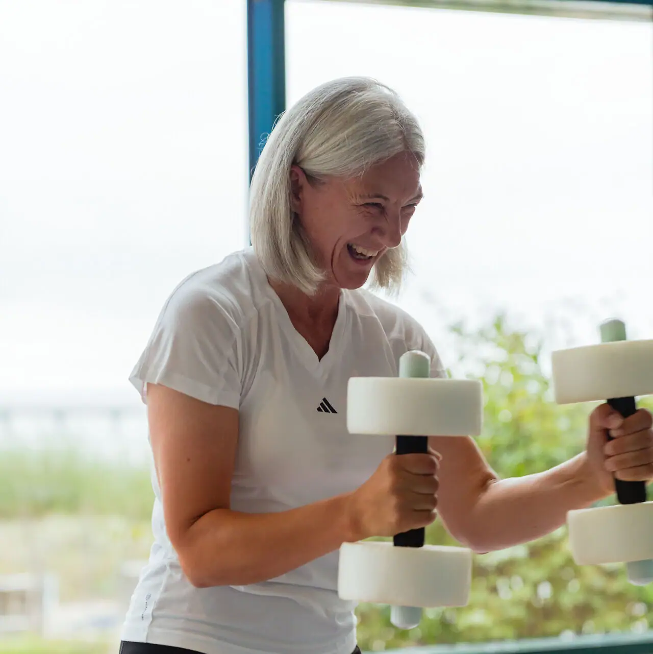 A woman is lifting weights at the gym.