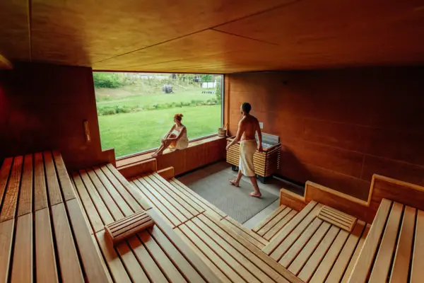 A man and a woman in a sauna.