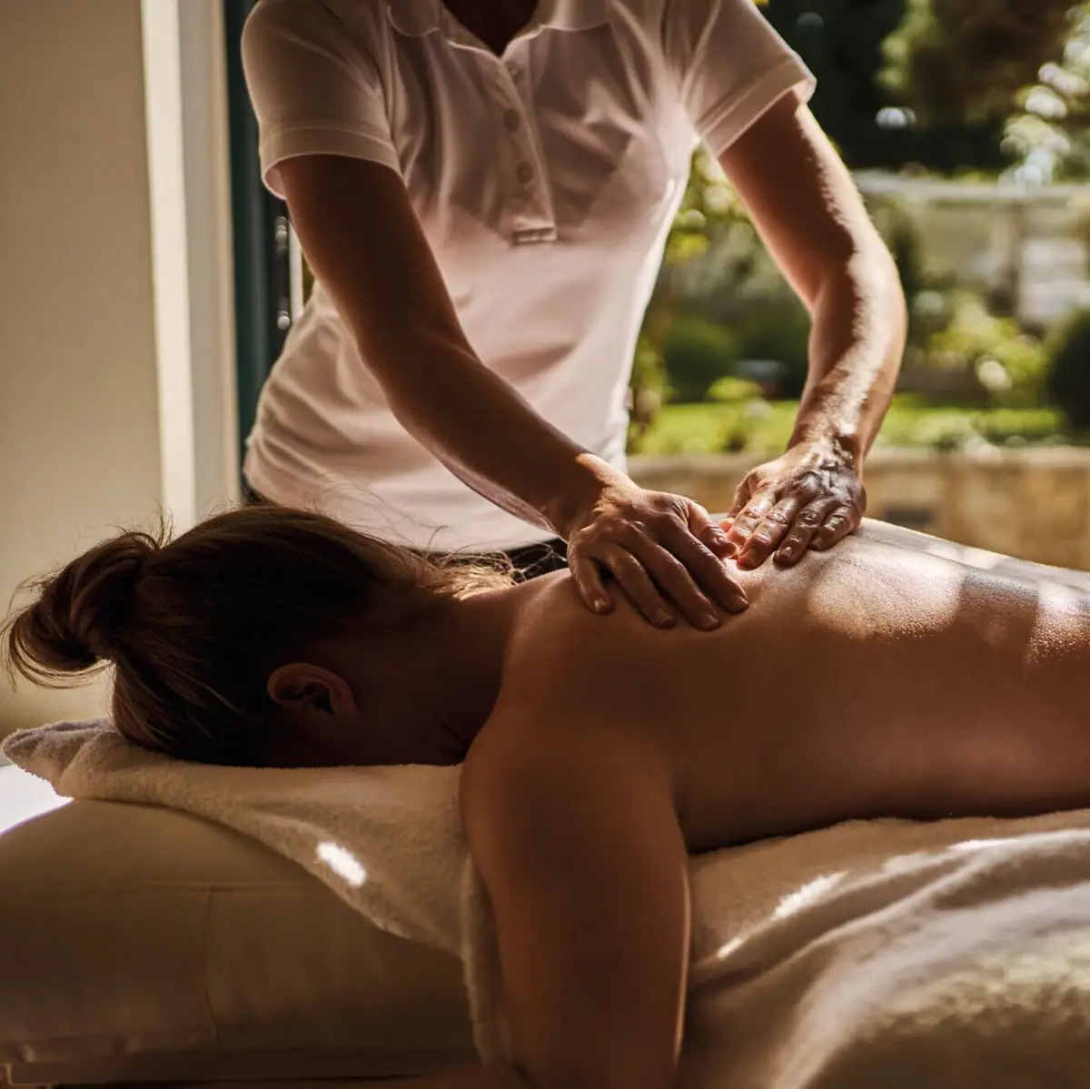 A woman receives a back massage.