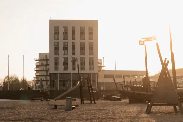 Building with boat and outdoor playground.