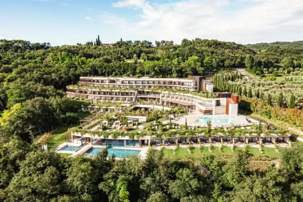 A-ROSA Lake Garda A building with a pool surrounded by trees.