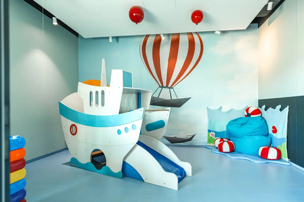 Playroom with boat slide and balloons