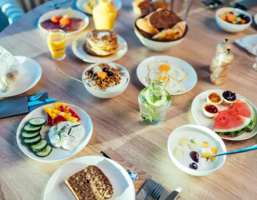 A table with plates full of food and drinks.
