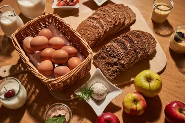A basket of eggs and bread on a table.