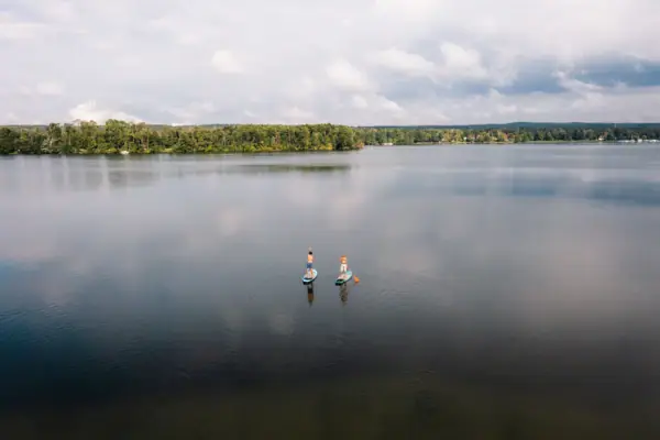 A group of people on paddleboards on a lake.