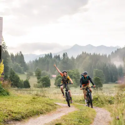 Mountain biking Two people are riding bicycles on a path.
