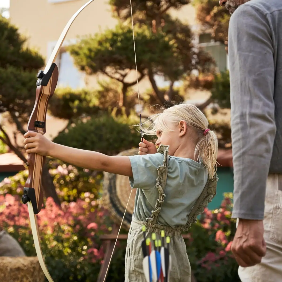 Girl holding bow and arrow during archery.