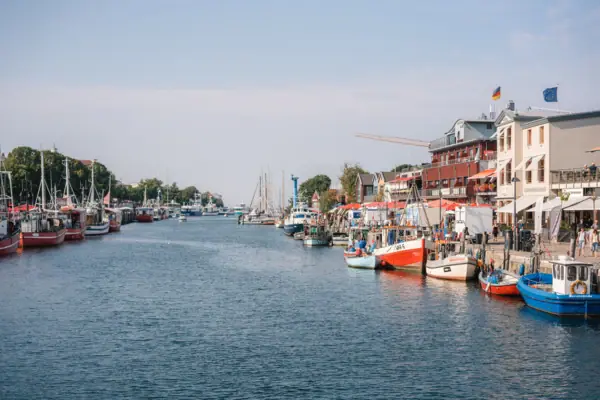 A river with boats and buildings in the background.