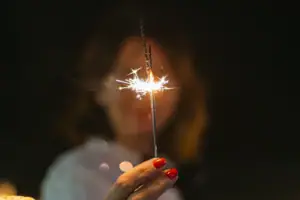 One person holds a sparkler.
