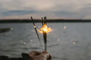 One hand holds a group of sparklers.