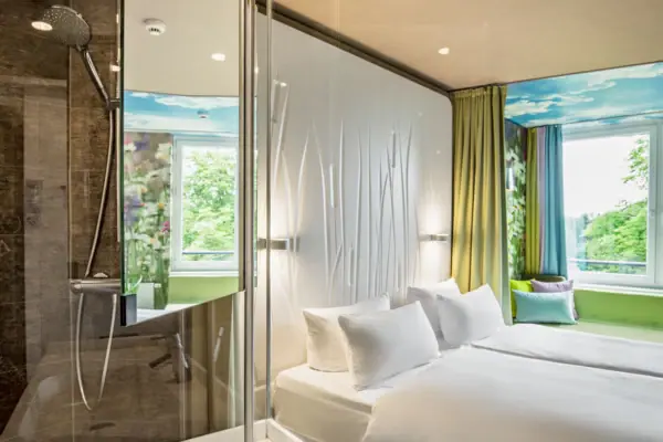 A room with a shower and a bed.