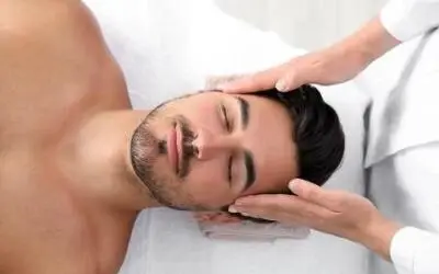 Man receives a massage in an interior room.