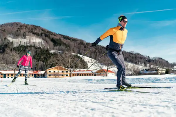 Cross-country skiing A man skiing on a snowy slope.