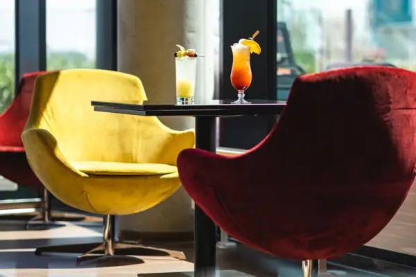 A table with two glasses of liquid on it.