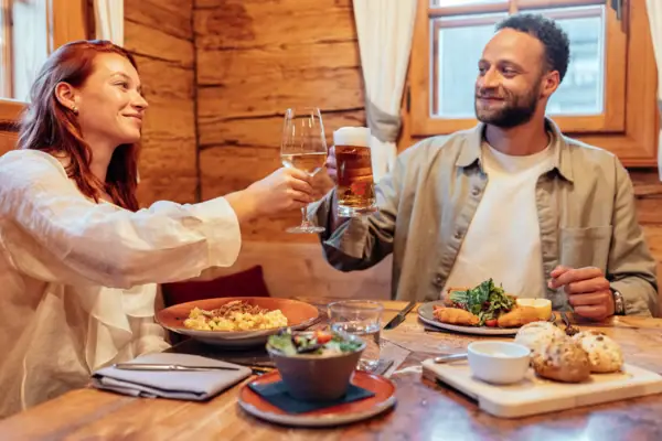 A man and a woman are holding wine glasses.