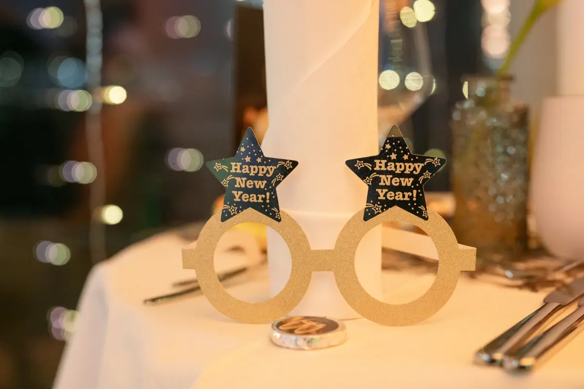 A pair of New Year’s Eve glasses on a table.