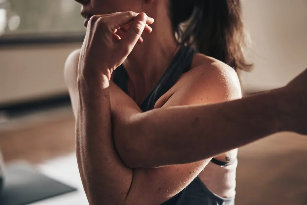 A woman is stretching out her arm.