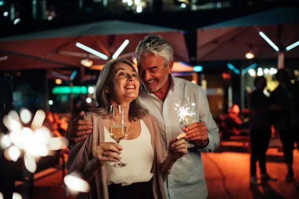 A man and a woman are holding wine glasses.
